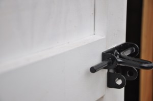 The door is made of 5/8 in. exterior plywood screwed and glued to a rail and stile frame. The tops of all the rails are beveled 5 degrees to shed water. Rails and stiles are joined with pocket screws and waterproof glue.